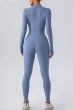 Blue jumpsuit worn by a person on a light gray background