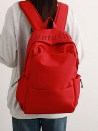 Red backpack with visible branding on a plain background