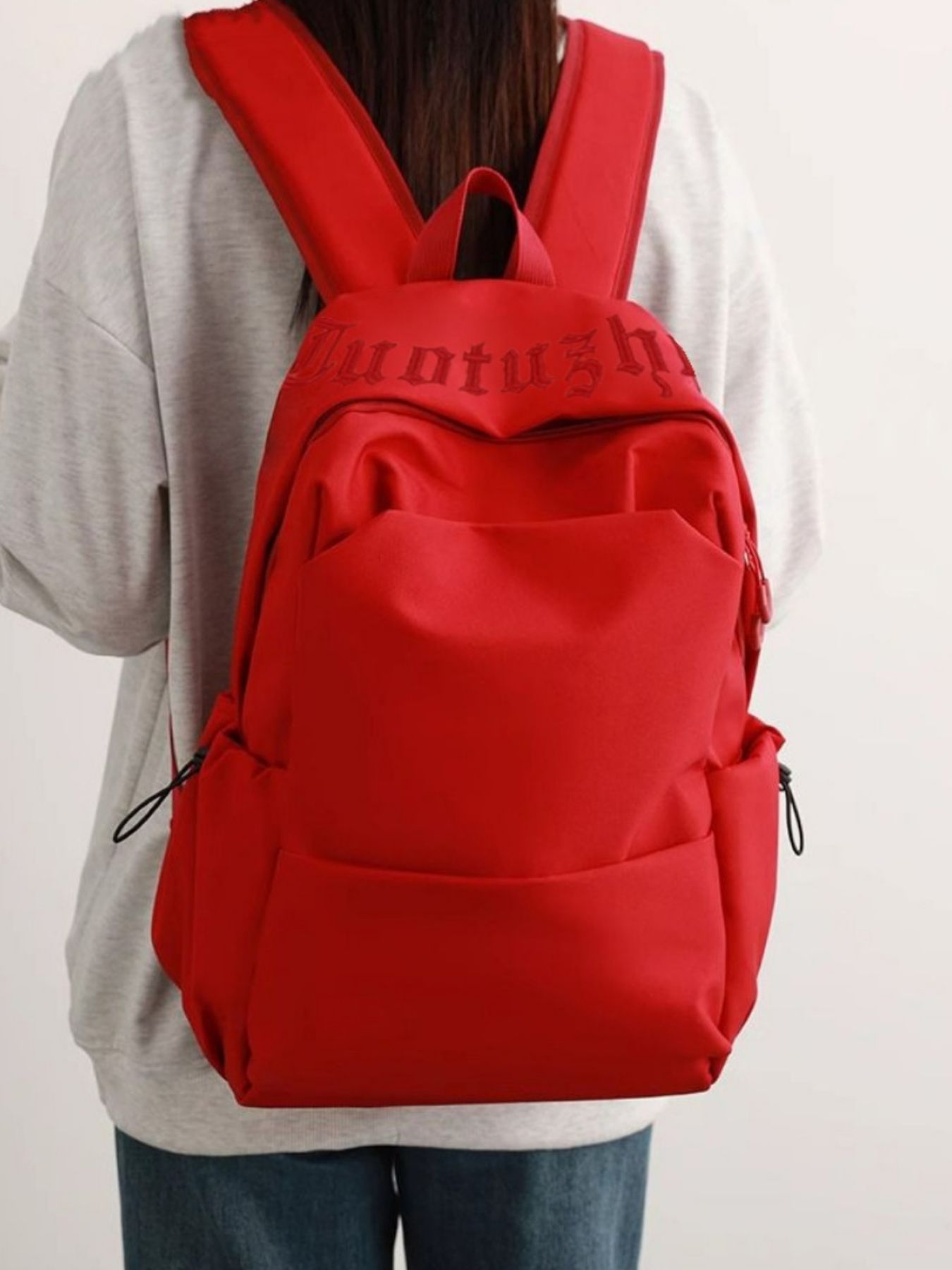 Red backpack with visible branding on a plain background