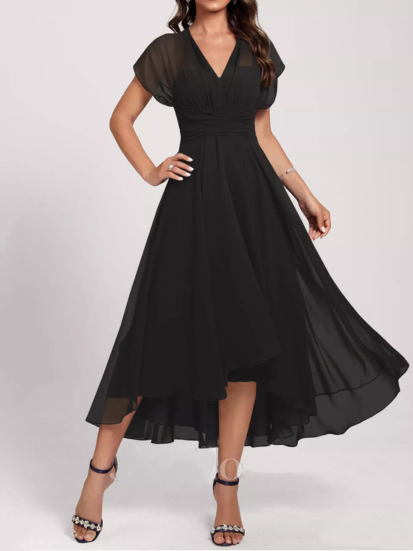 Black dress with sheer sleeves on a white background