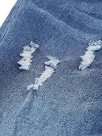 Close-up of distressed blue denim fabric