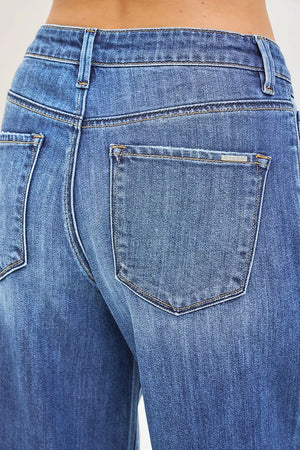 Close-up of blue jeans with a focus on the back pocket.