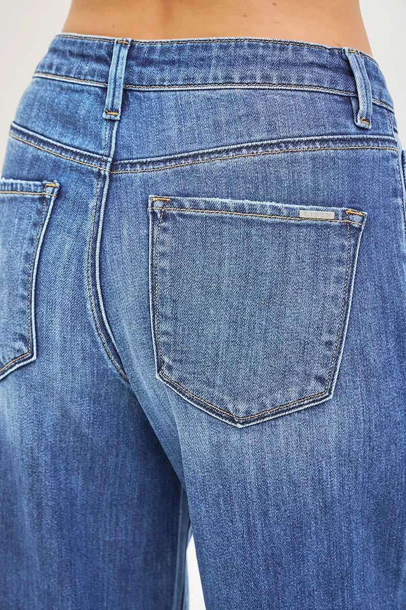 Close-up of blue jeans with a focus on the back pocket.