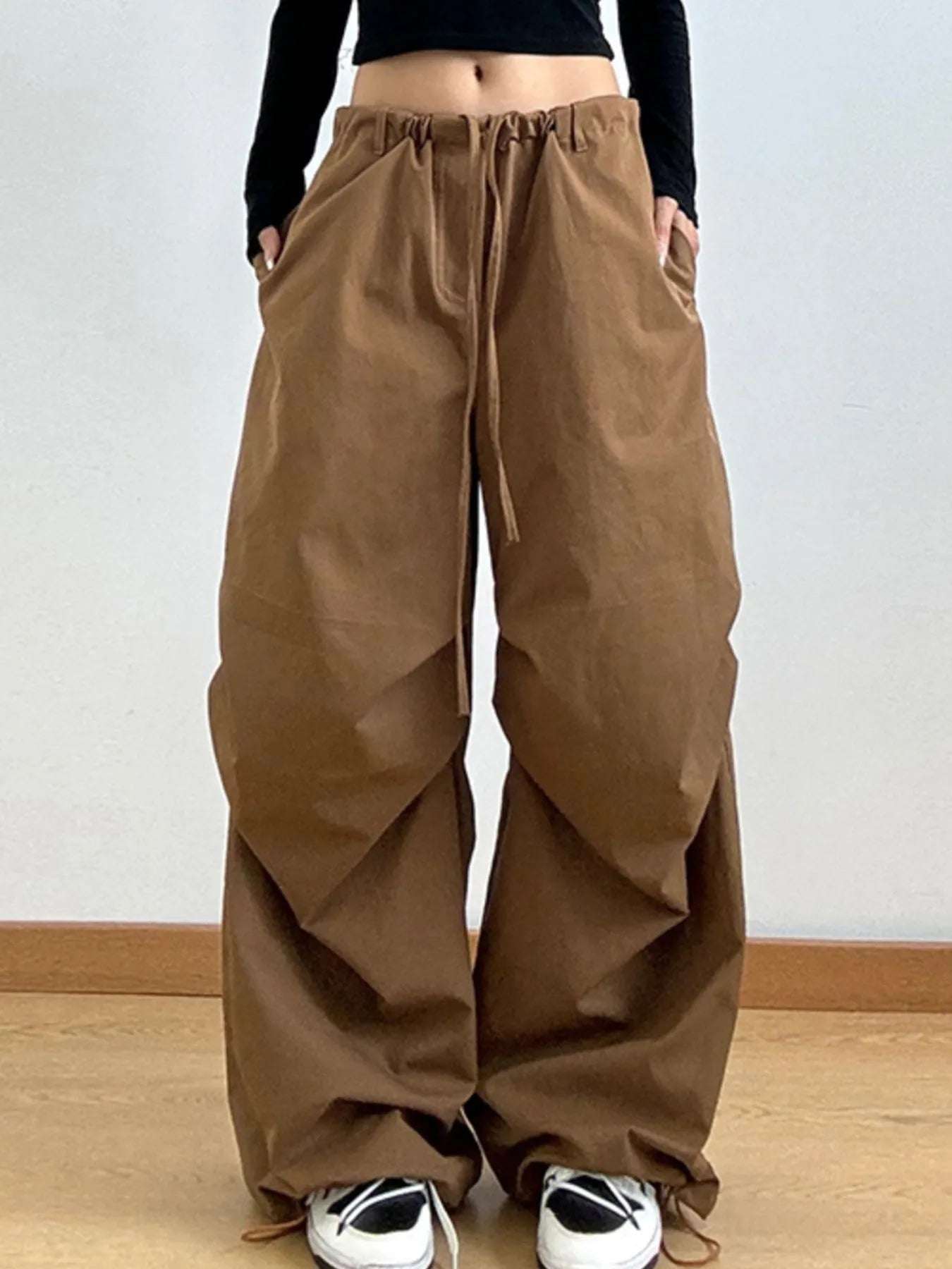 Brown wide-leg pants worn by a person on a plain background
