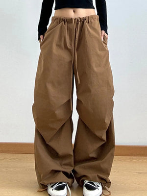Brown wide-leg pants worn by a person on a plain background