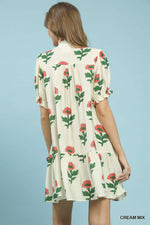 Woman wearing a floral dress with a cream background
