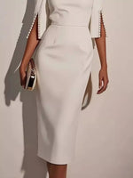 White outfit with a skirt and jacket on a plain background