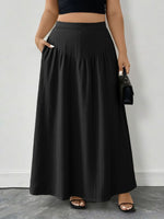 Person wearing a black skirt with a plain background