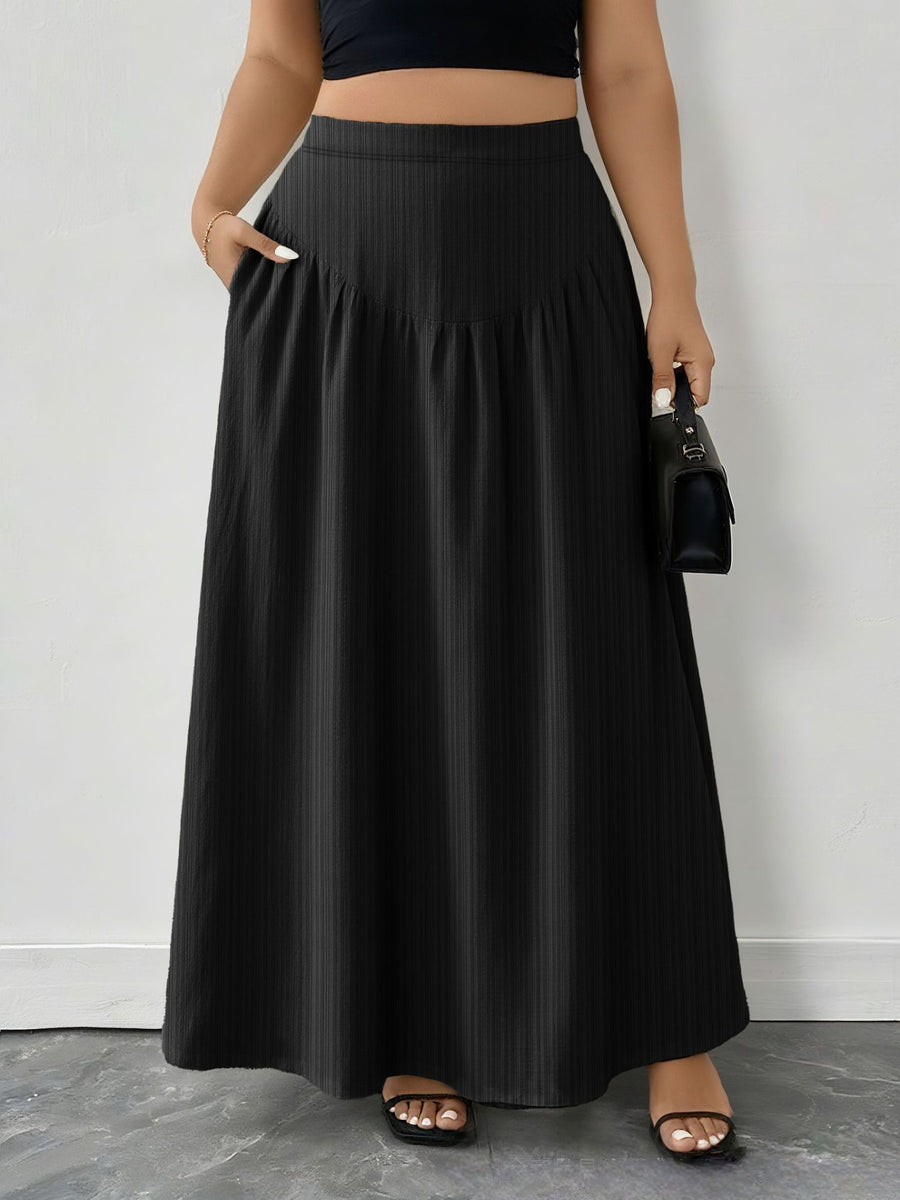 Person wearing a black skirt with a plain background