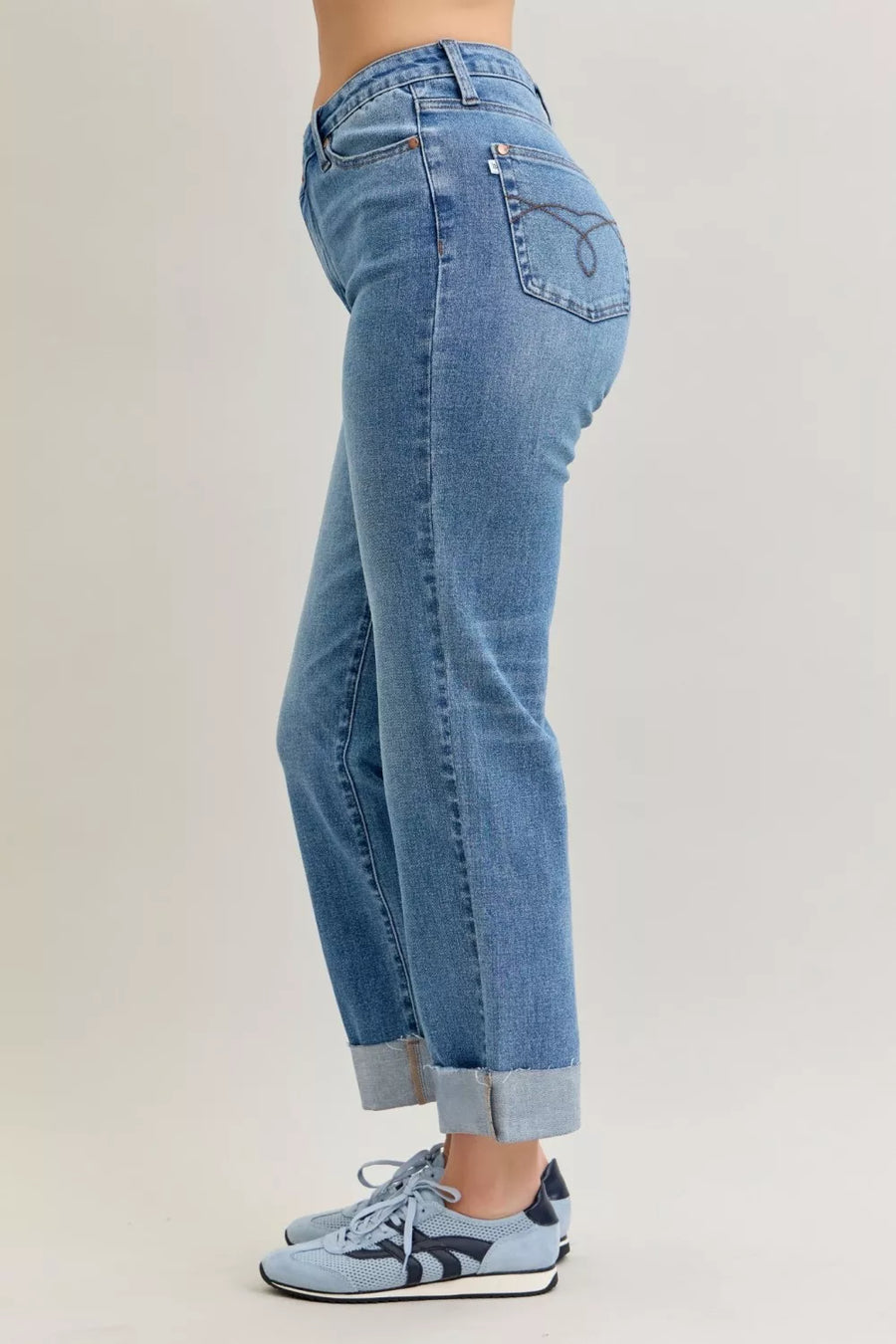Light blue jeans worn by a person on a plain background