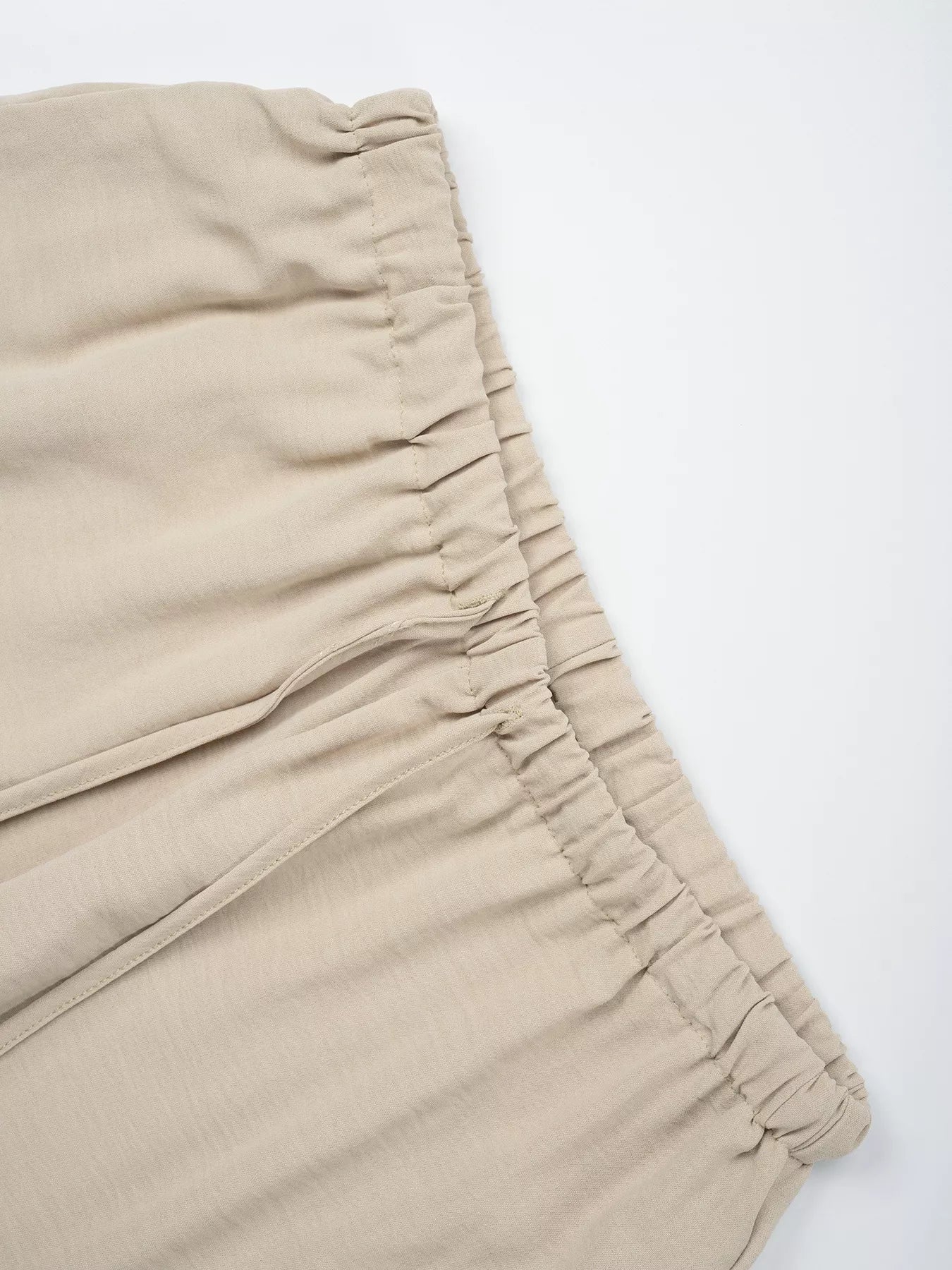 Beige pants with a white background