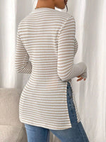 Person wearing a textured long-sleeve top with a neutral background