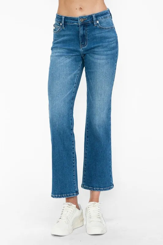 Blue jeans worn by a person on a white background