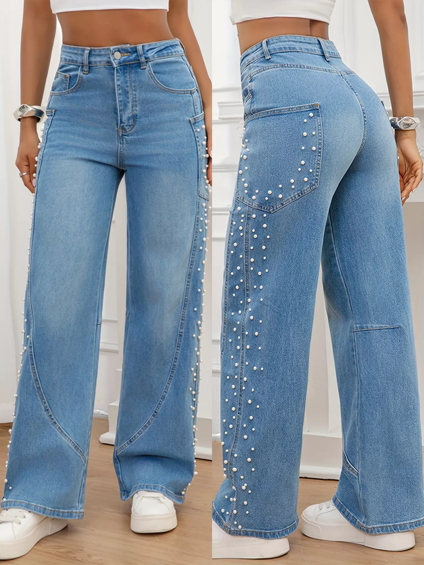 Pair of blue jeans with embellishments on a plain background
