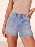 Person wearing light blue denim shorts and a beige striped top on a beige background
