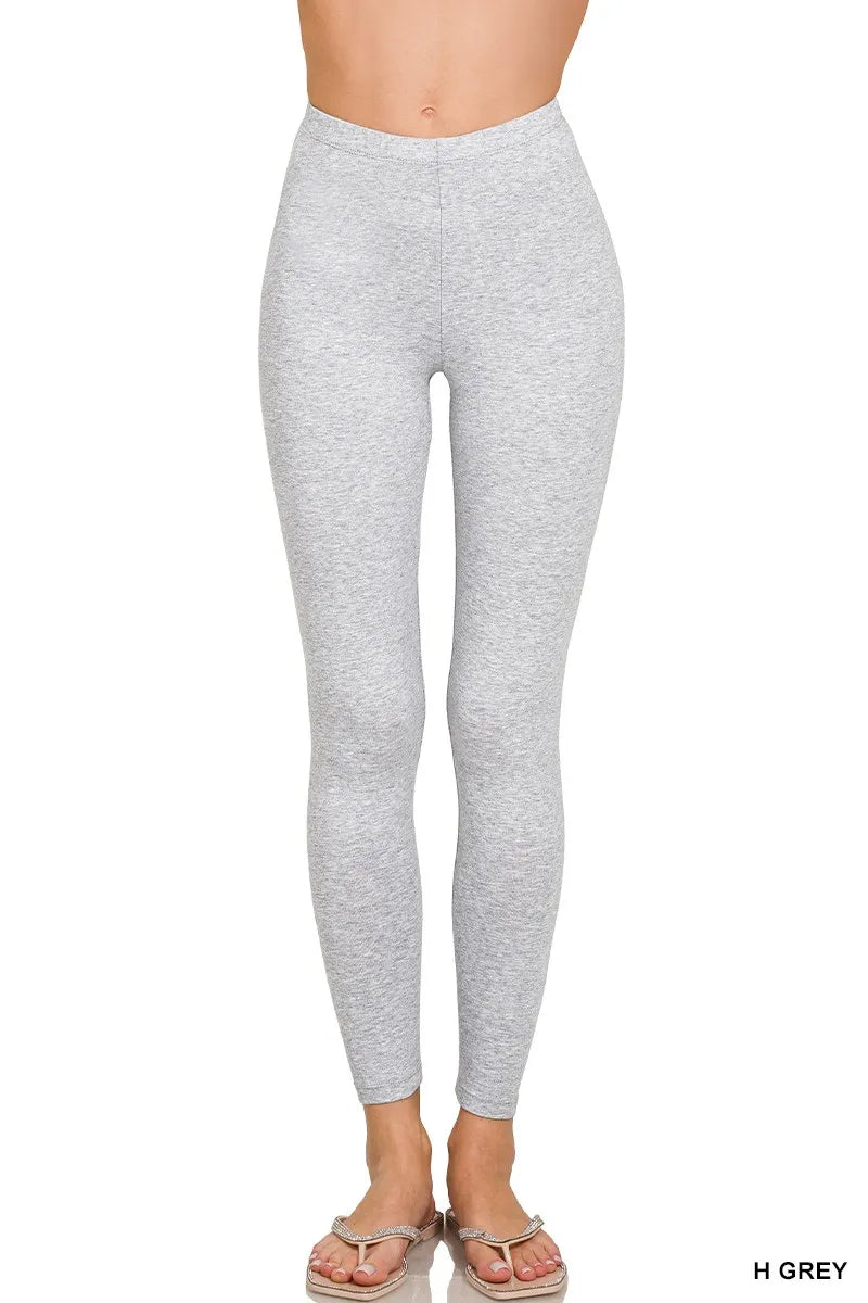 Gray leggings worn by a person on a white background