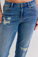 Blue jeans with slight distressing on a plain background