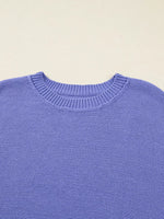 Close-up of a blue sweater with a beige background