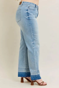 Light blue jeans worn by a person on a plain background