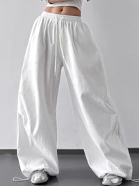 White wide-leg pants worn by a person on a plain background