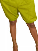 Green shorts worn by a person on a white background