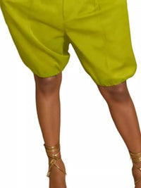 Green shorts worn by a person on a white background
