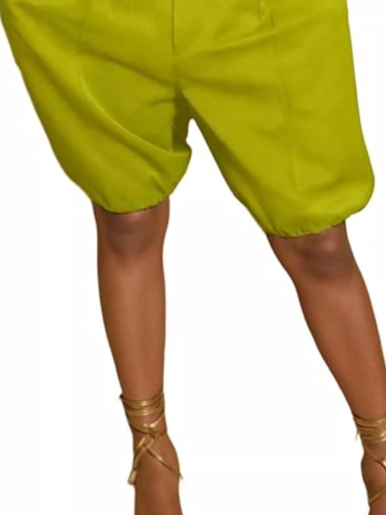 Green shorts worn by a person on a white background