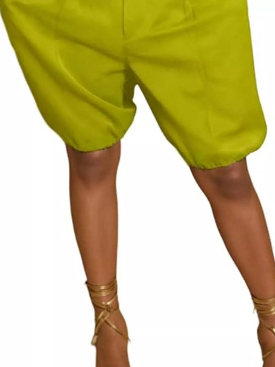 Green shorts worn by a person on a white background