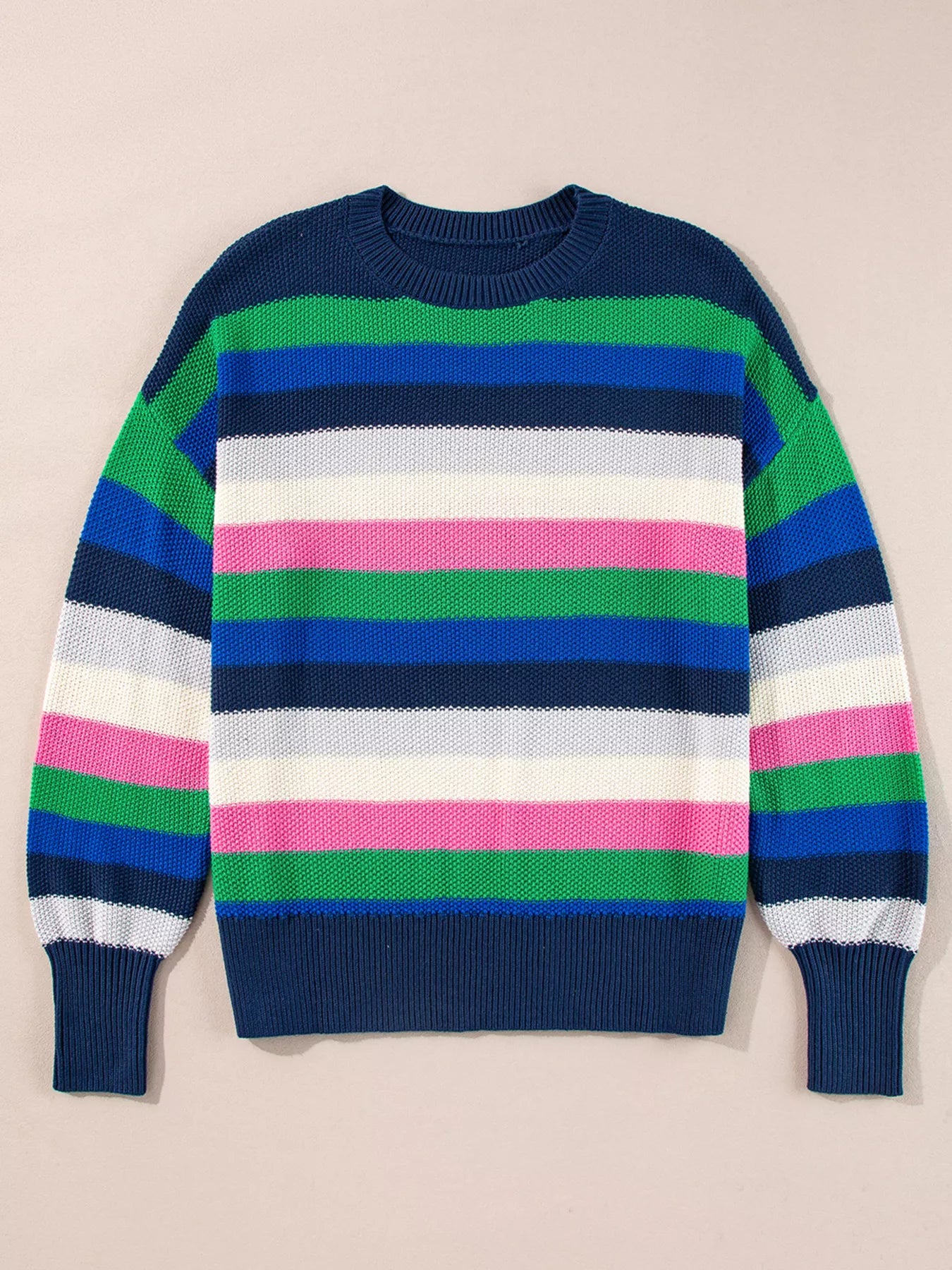 Colorful striped sweater on a beige background