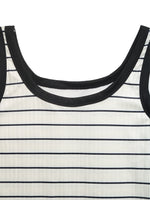 Close-up of a black and white striped dress with a focus on the neckline.
