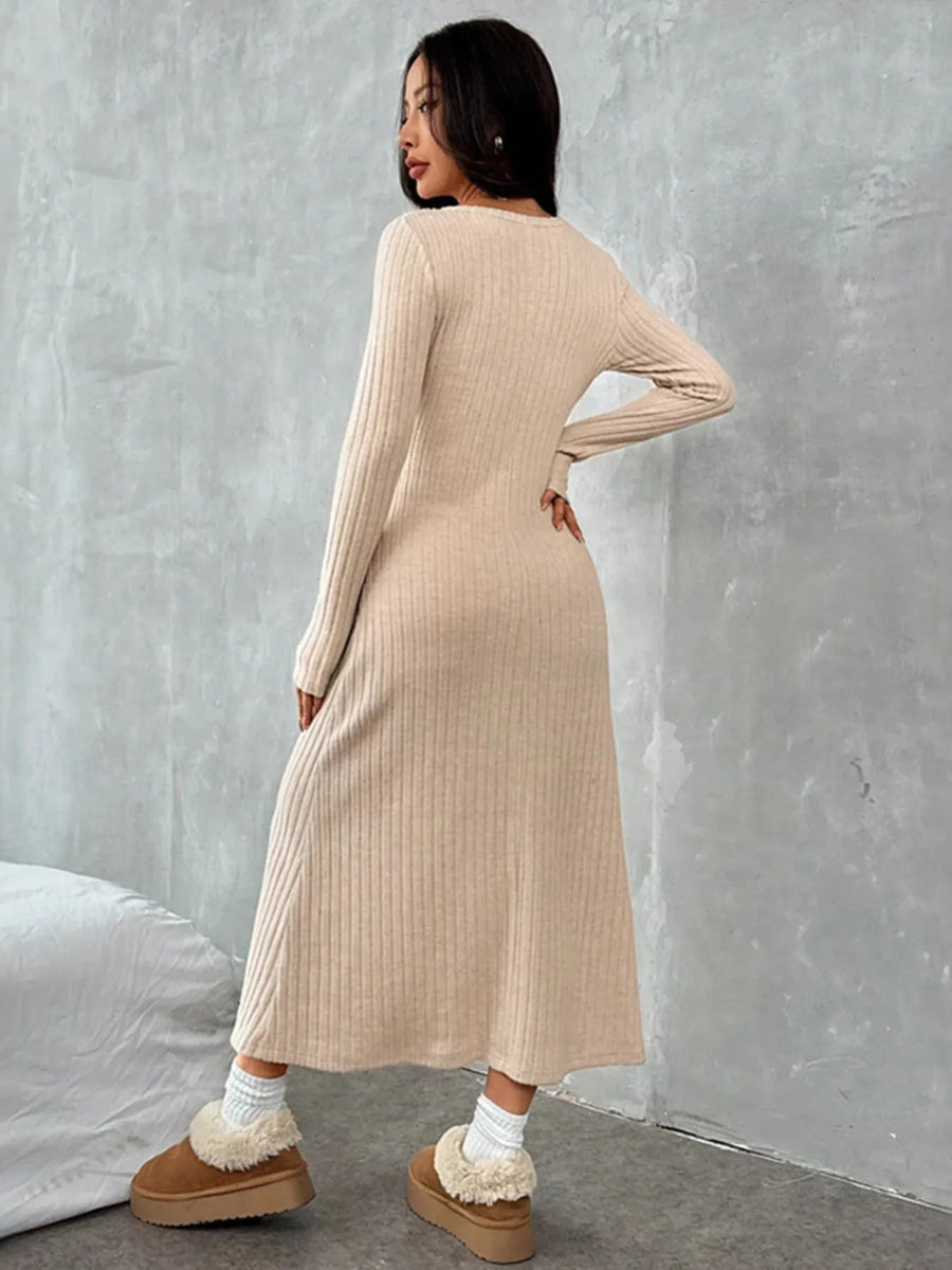 Woman wearing a beige ribbed dress against a gray wall