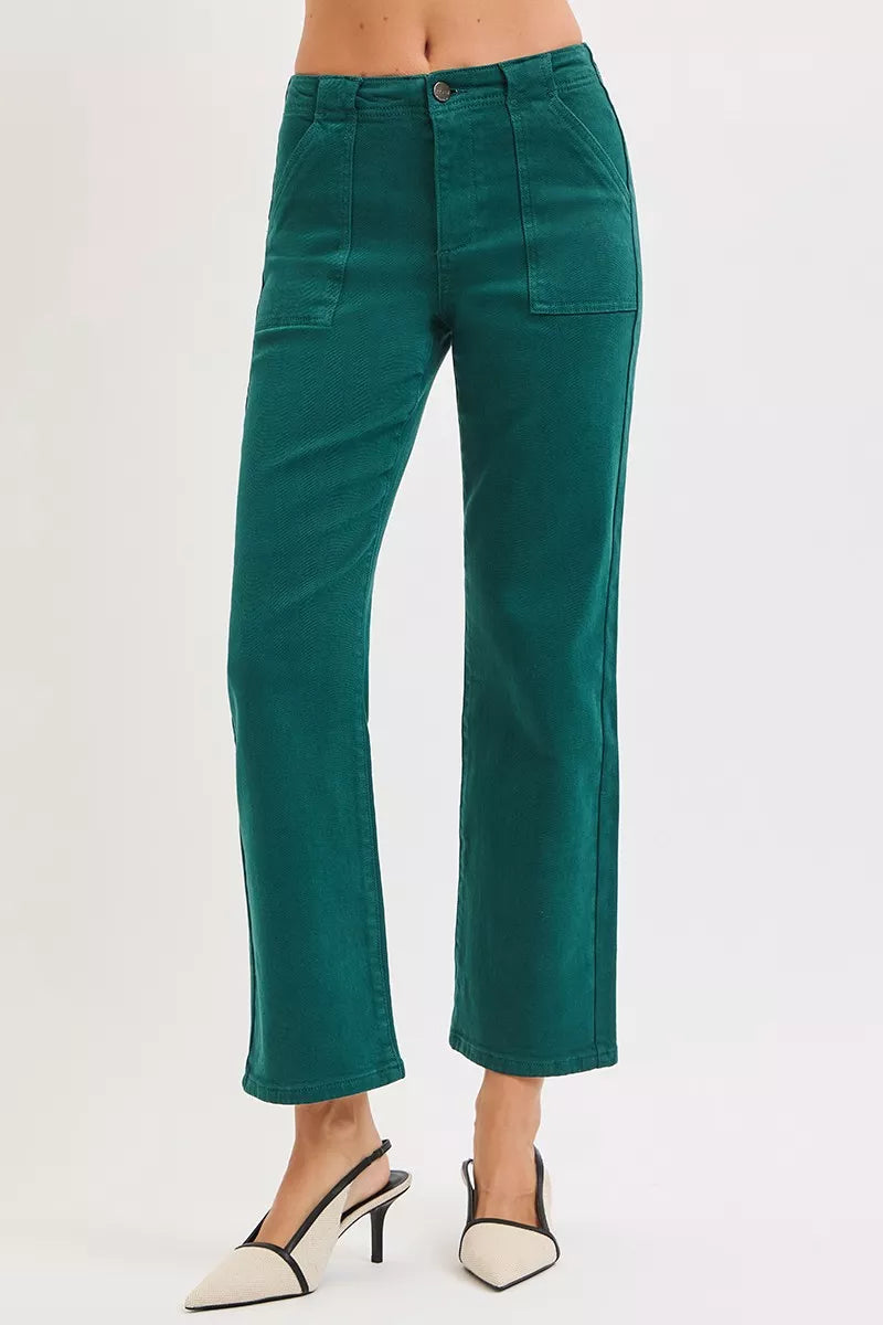 Teal pants worn by a person on a light gray background