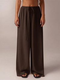 Brown wide-leg pants worn by a person on a plain background