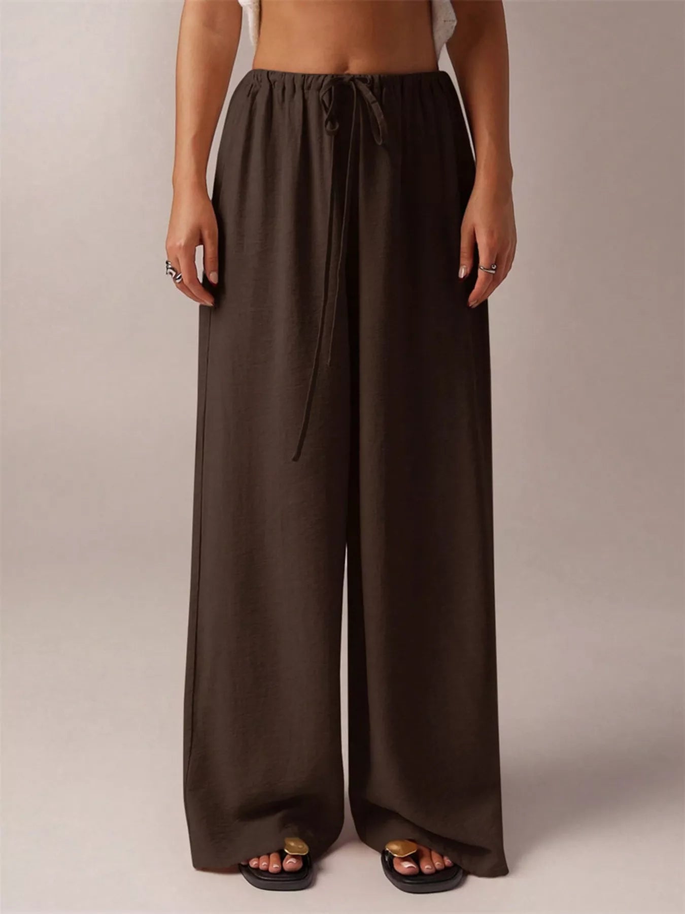 Brown wide-leg pants worn by a person on a plain background