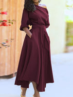 Woman wearing a burgundy dress with a blurred background