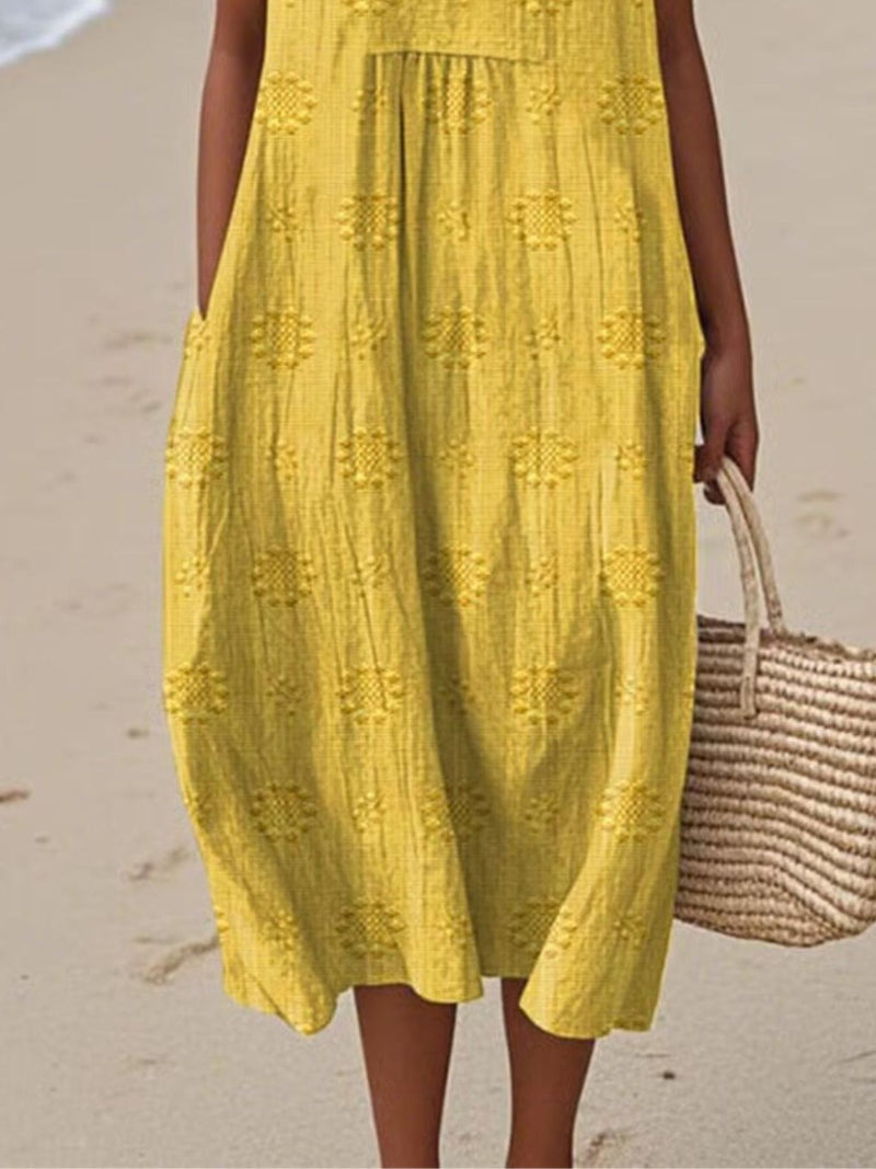 Person wearing a yellow dress on a beach