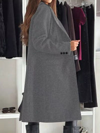 Person wearing a gray coat in a clothing store setting