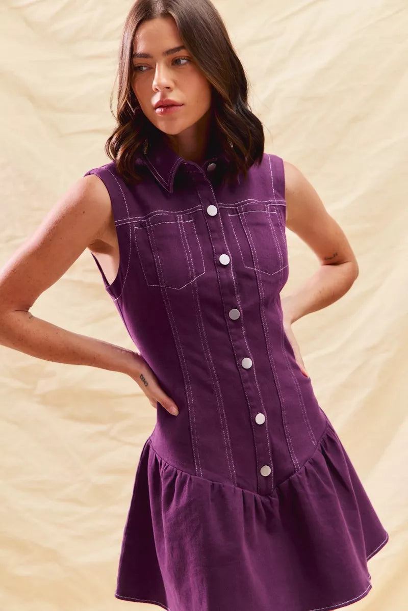 Woman wearing a purple dress with a beige background