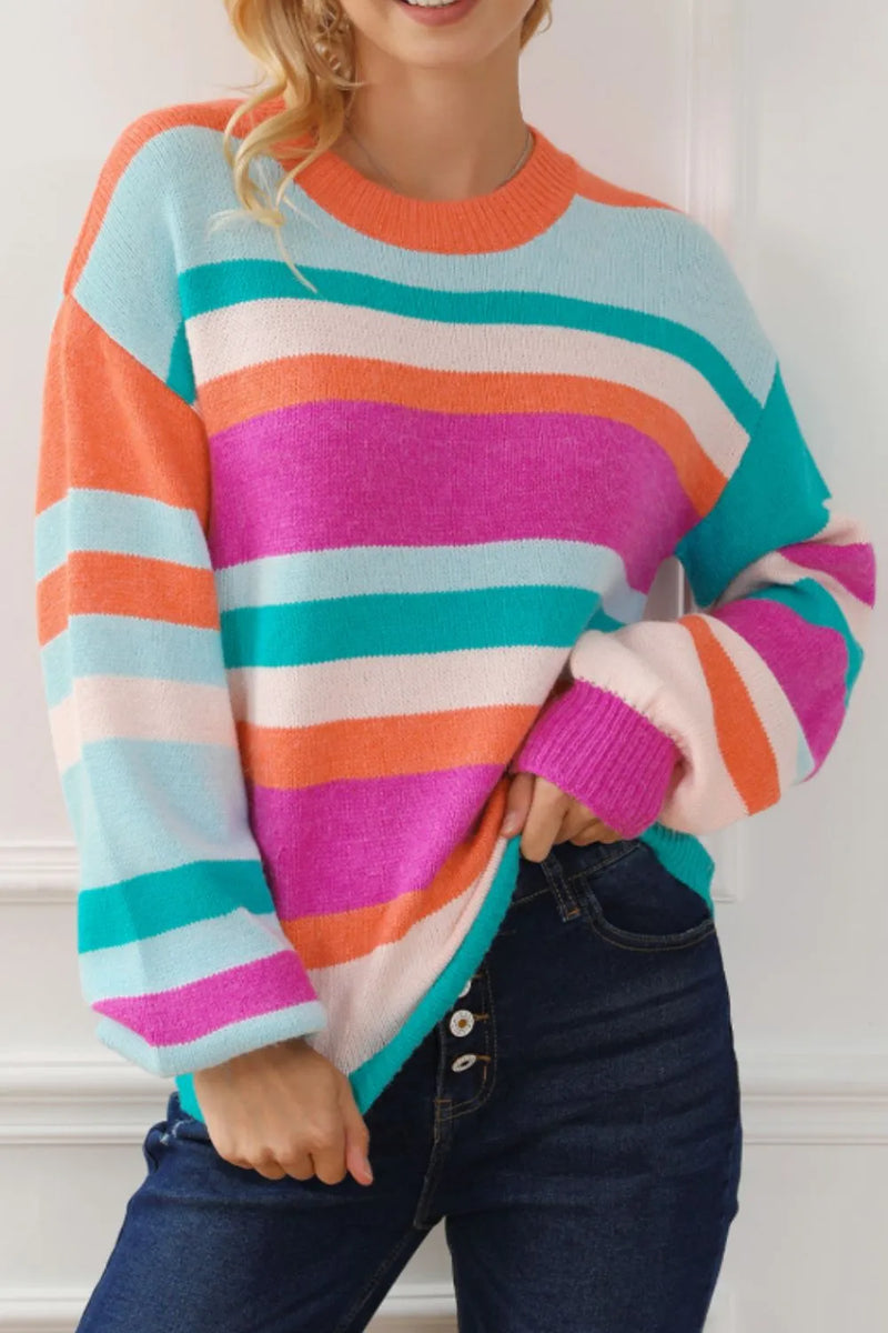 Person wearing a colorful striped sweater with a white background
