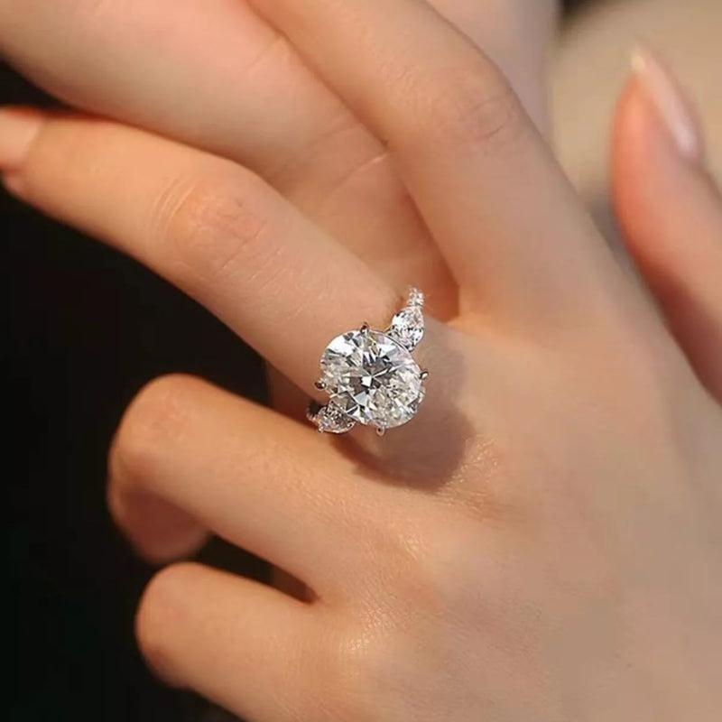 Diamond ring on a finger against a dark background
