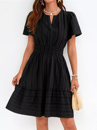 Woman wearing a black dress with a white background