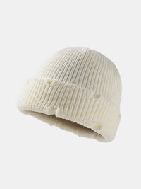Beige knit beanie on a white background