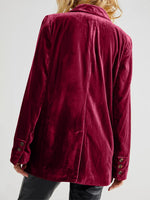 Maroon corduroy jacket worn by a person on a white background