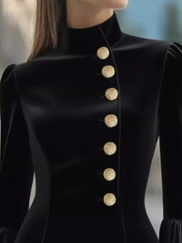 Black coat with gold buttons on a blurred background