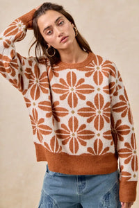 Woman wearing a patterned sweater with a beige background