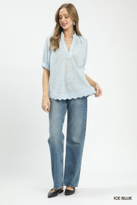Woman wearing a light blue blouse and jeans on a white background