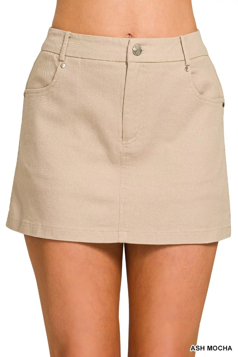 Beige skirt worn by a person on a white background