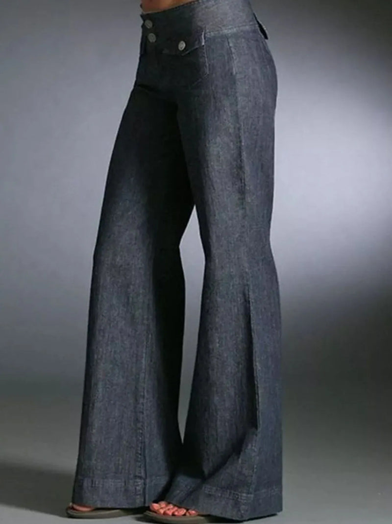 Blue denim bell-bottom pants on a gray background