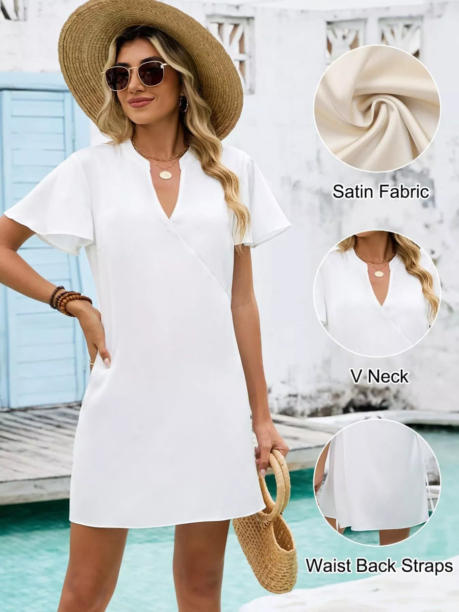 Woman wearing a white dress with a straw hat by a pool, with fabric details shown.