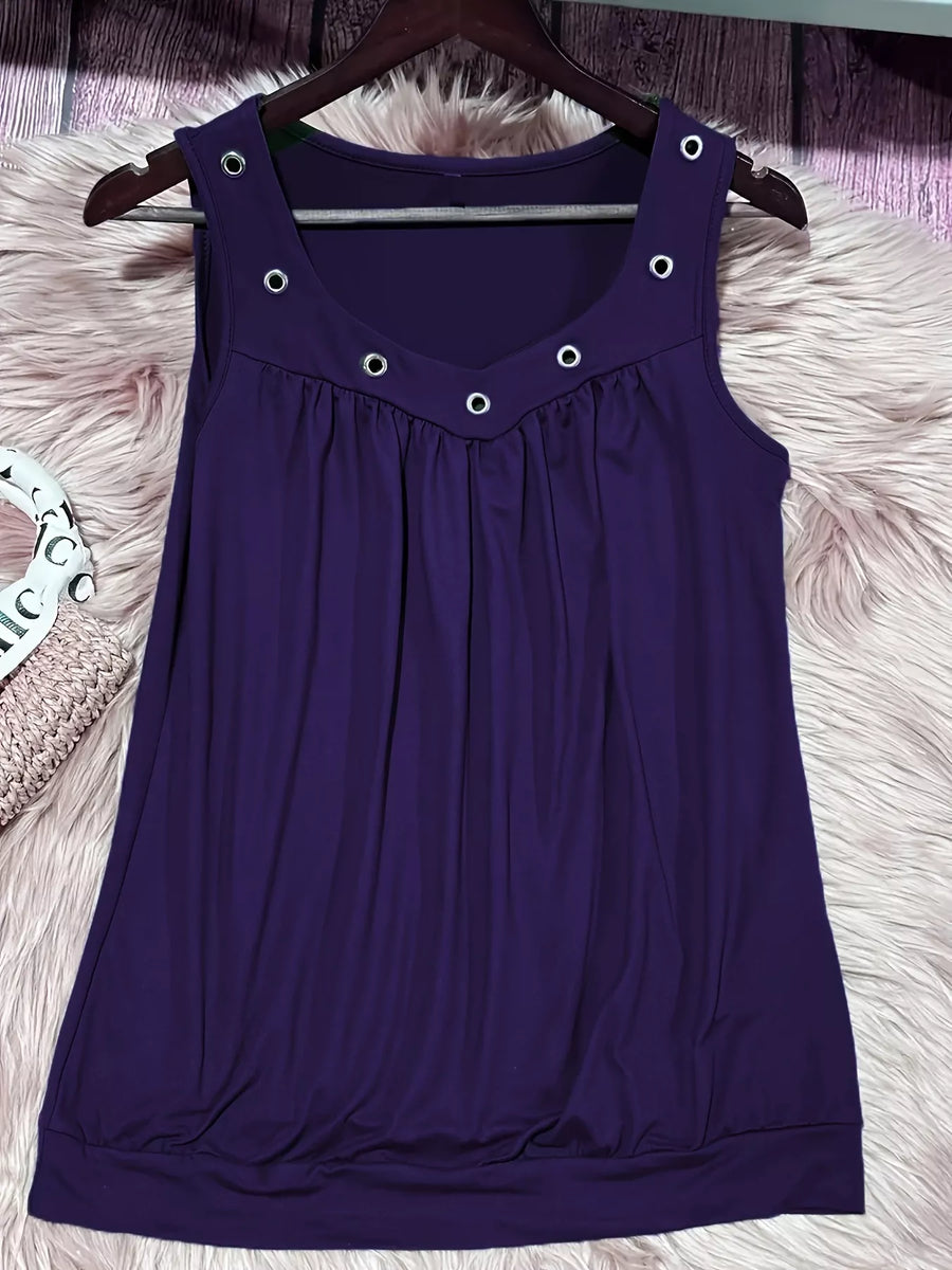 Purple sleeveless dress with button details on a hanger against a fluffy white surface.